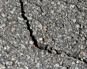 Paved asphalt surface with a large crack